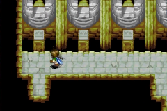 The hall lined with stone faces