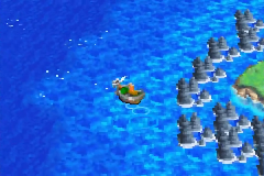 The islet ringed by rocks on the way north
