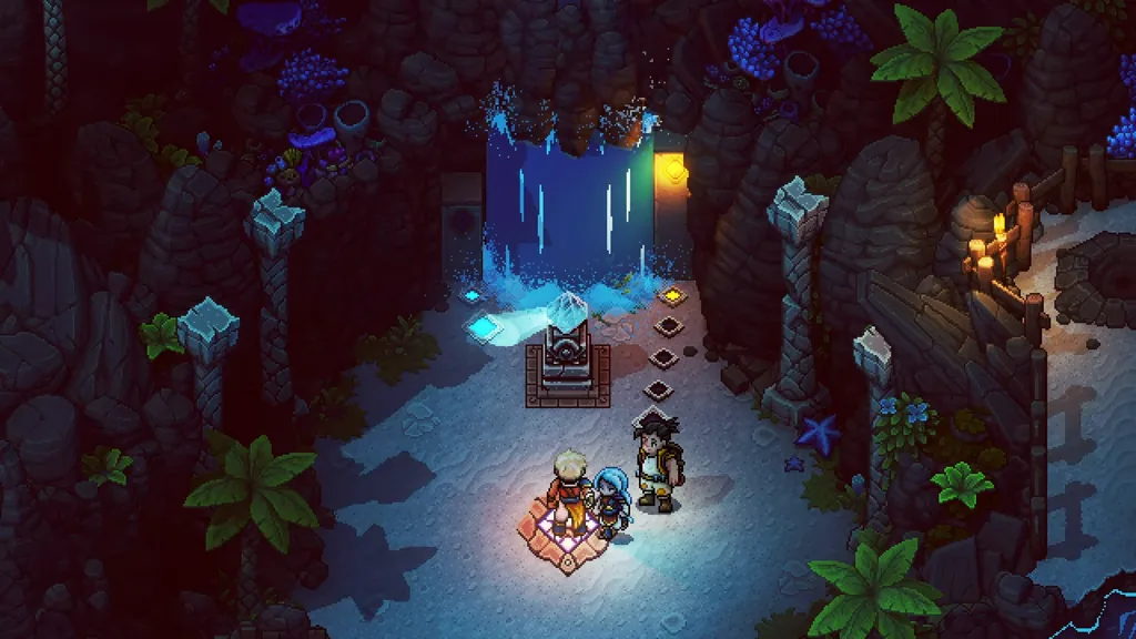 A waterfall between glowing posts at night