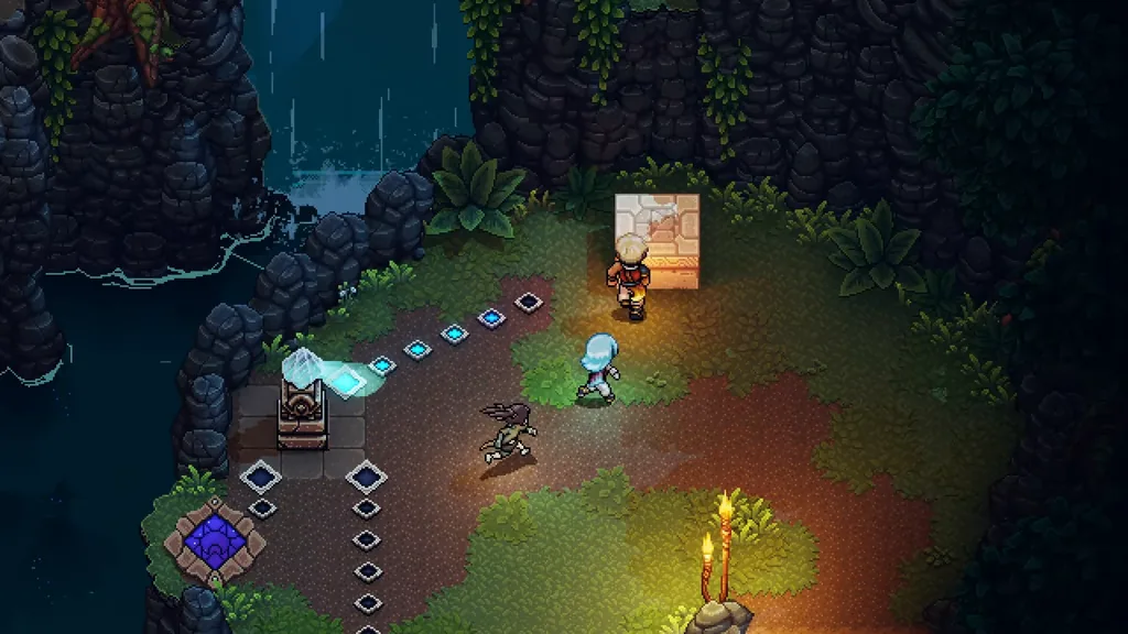 A glowing stepping-stone path by the waterfall